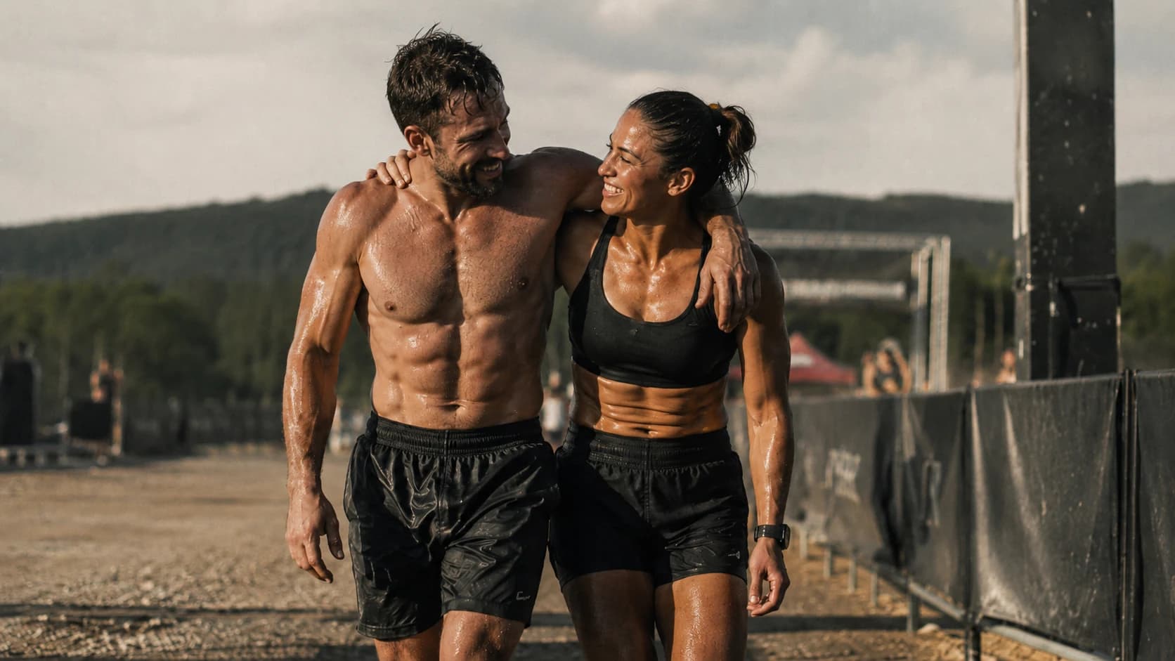 Two athletes smiling and supporting each other after a difficult effort